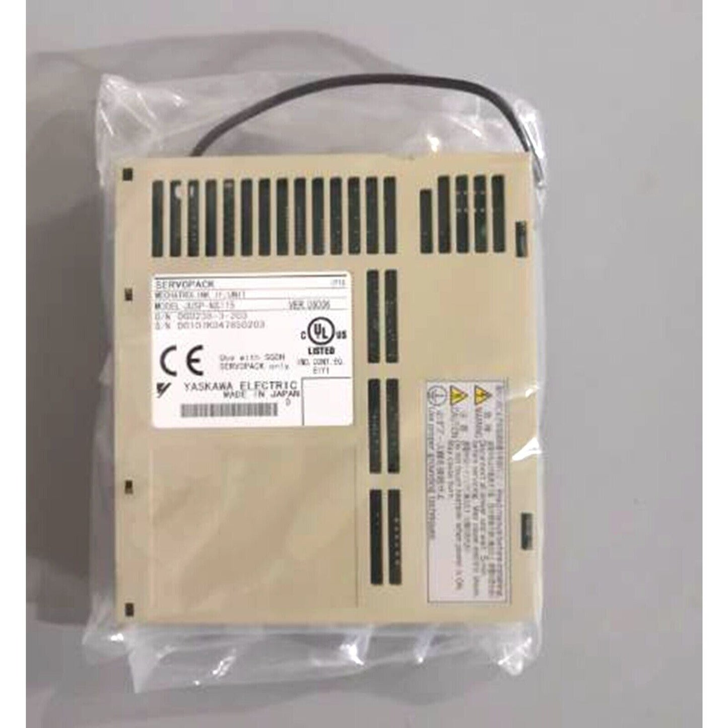 YASKAWA JUSP-NS115 Servo Drive, beige SERVOPACK unit, Made in Japan, industrial automation part, in plastic packaging.