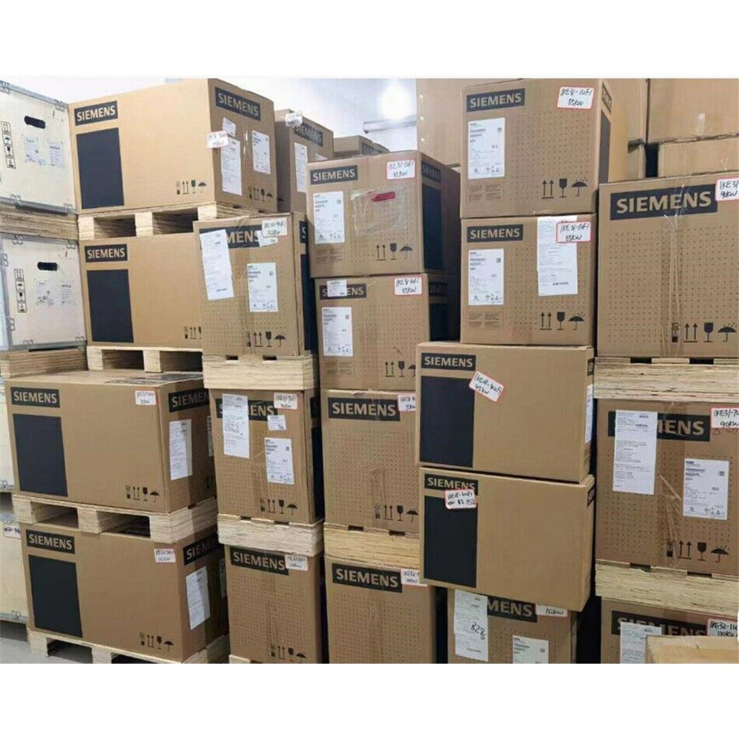 Siemens SINAMICS G120C Power Module boxes stacked on pallets, industrial automation parts inventory