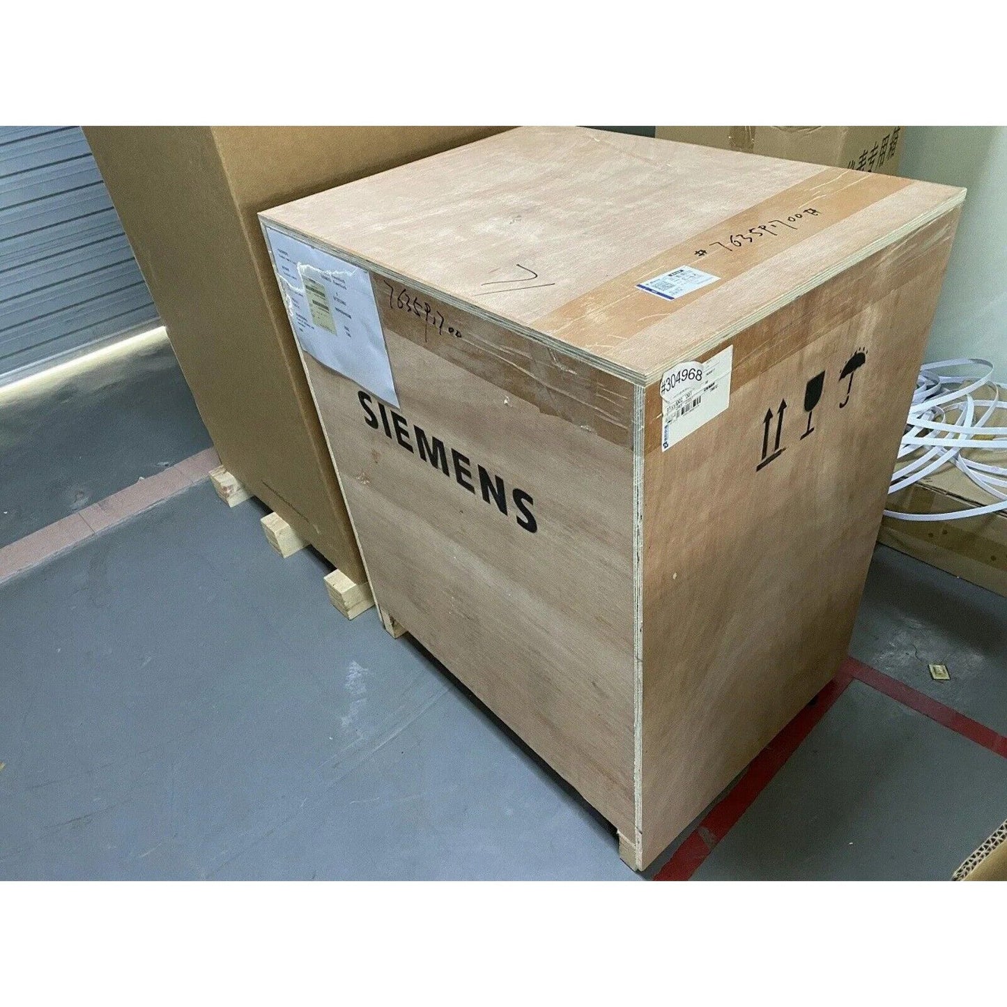 Siemens industrial part in wooden crate, product packaging.