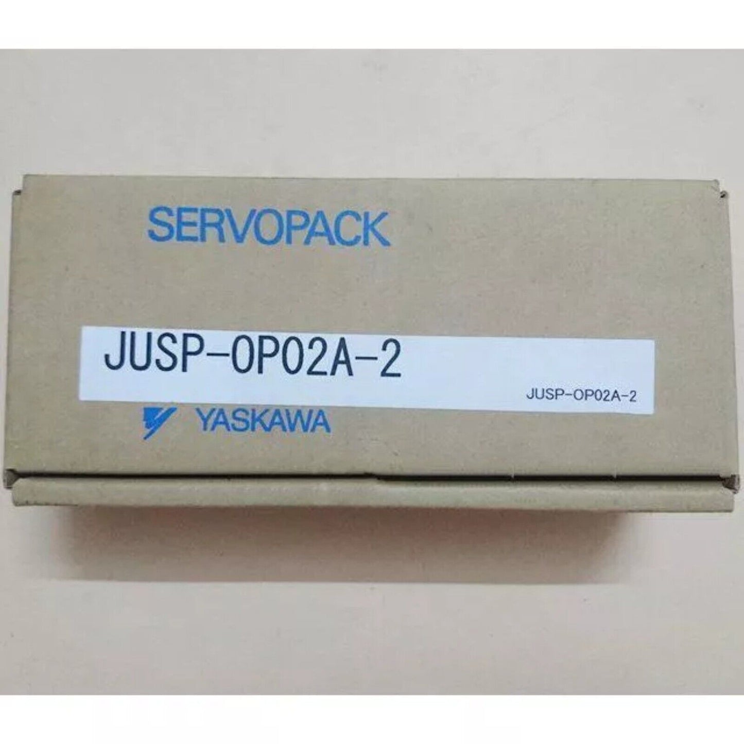 YASKAWA JUSP-OP02A-2 operation panel in a cardboard box with SERVO PACK label. Industrial automation equipment.