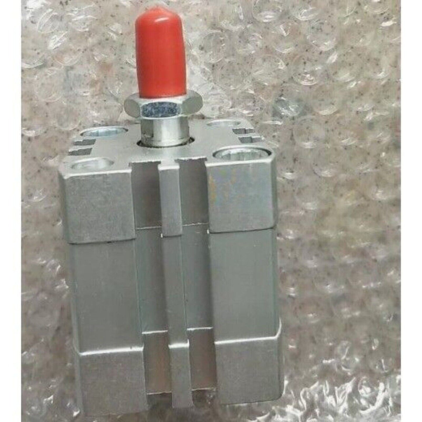 FESTO ADN-32-10-A-P-A cylinder. Silver pneumatic cylinder with red cap, industrial automation part.