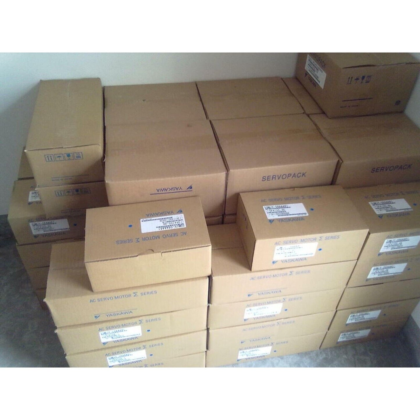 YASKAWA AC Servo Motors in boxes, ready for expedited shipping. Industrial automation parts.