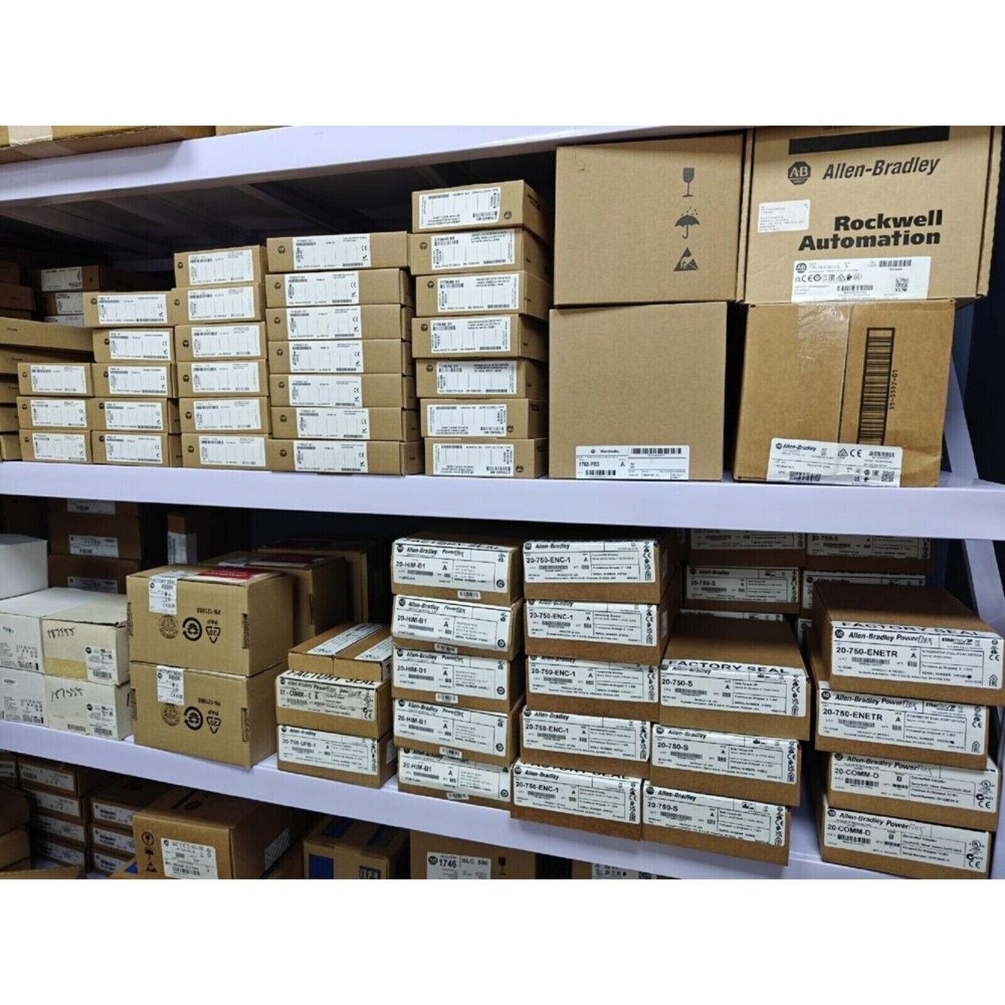 Industrial automation parts warehouse with Allen-Bradley, Rockwell Automation boxes on shelves, ready for shipment.