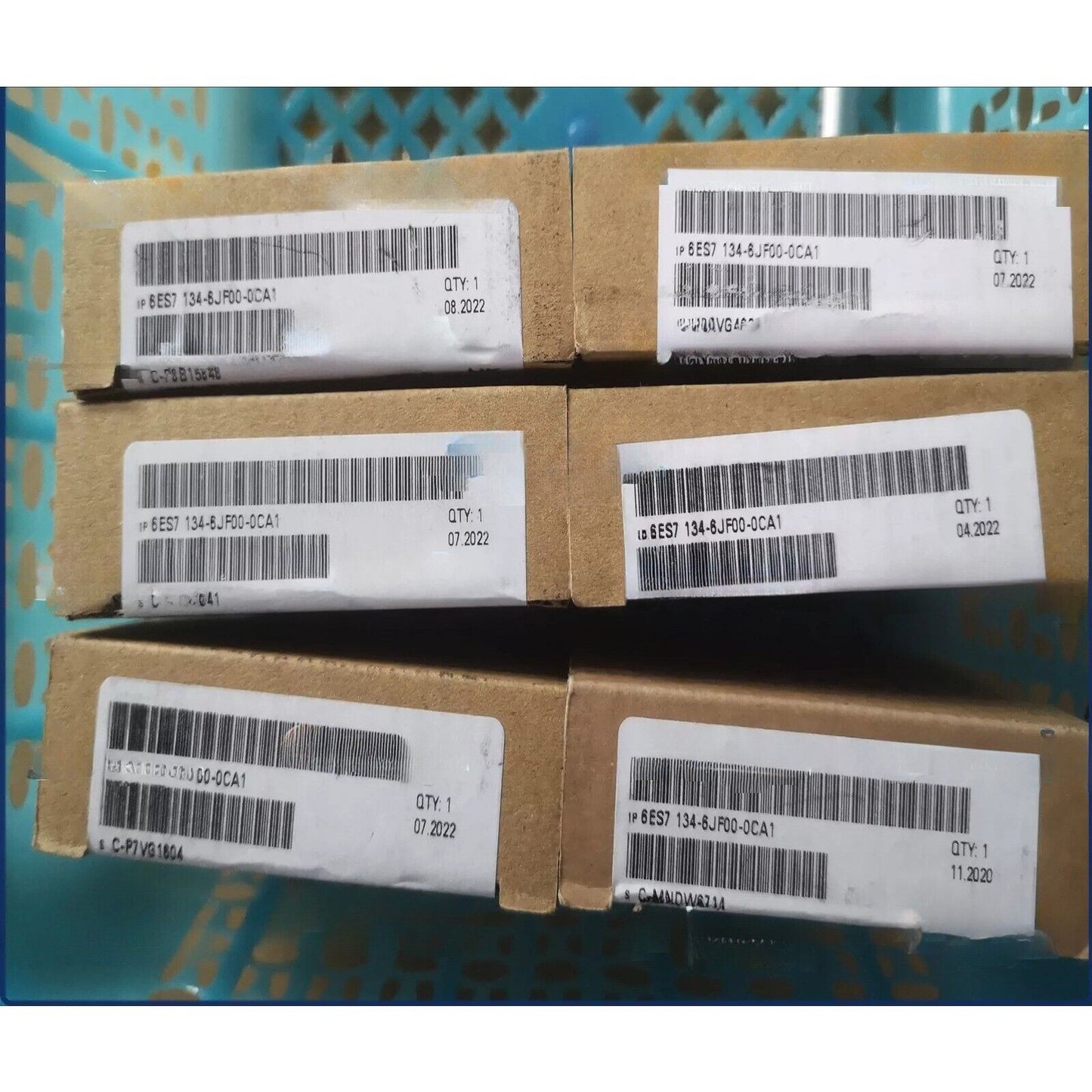 Siemens SIMATIC ET 200SP 6ES7134-6JF00-0CA1 modules in boxes, with product labels and barcodes, for industrial automation.
