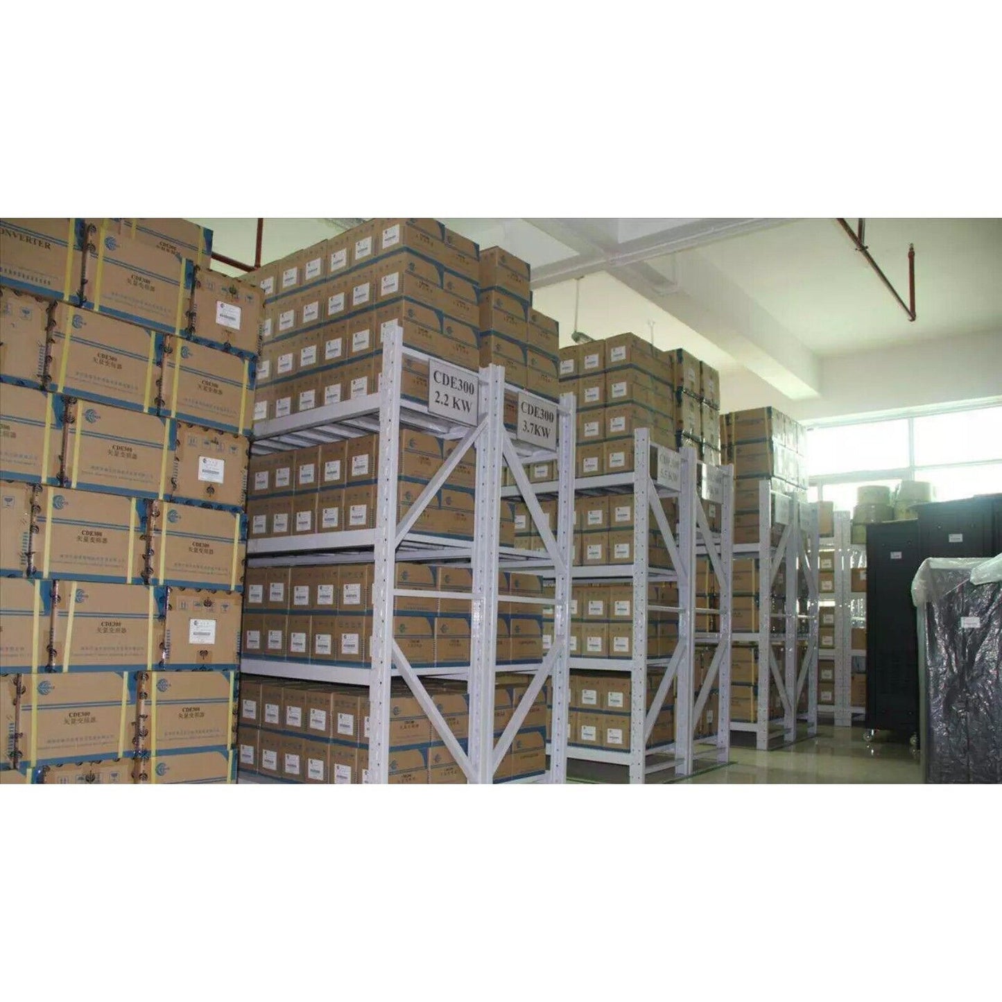 Warehouse storage of CDE300 industrial automation components, 2.2KW and 3.7KW models.