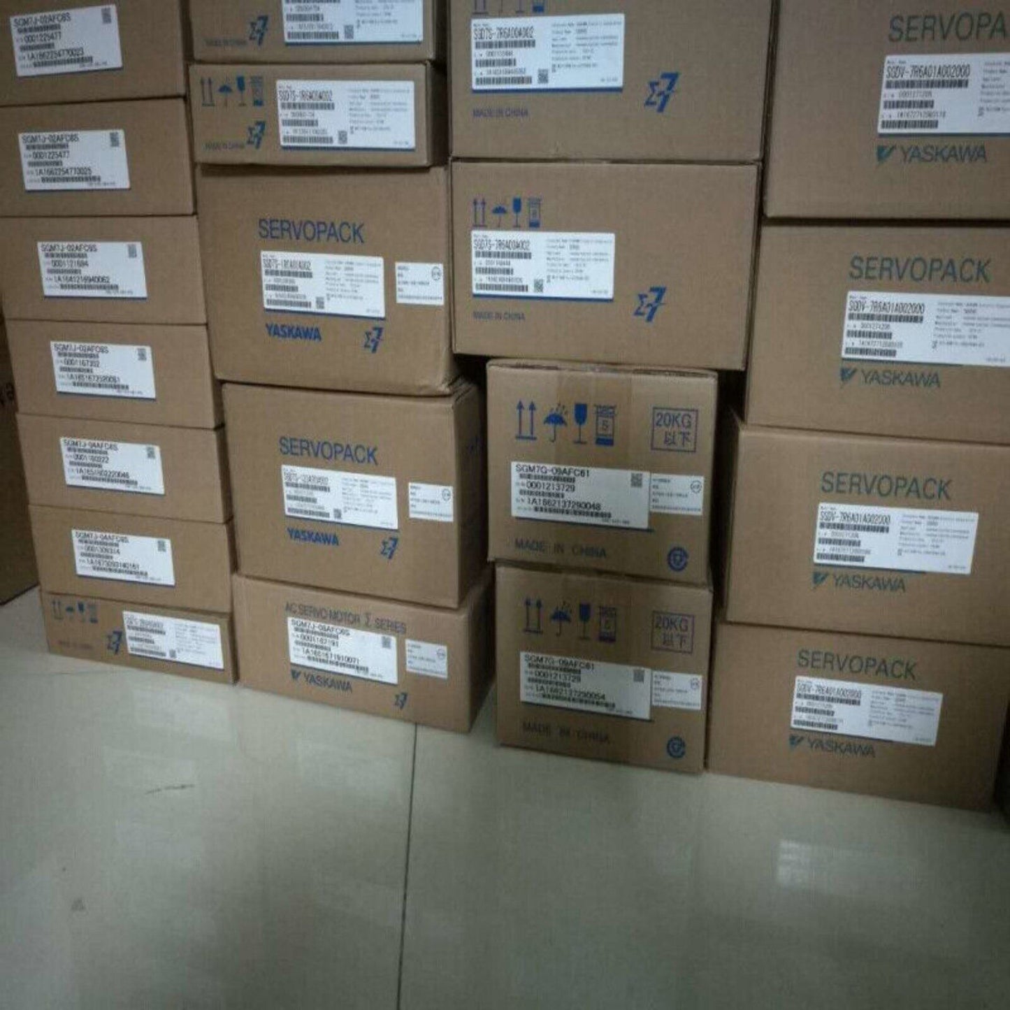 Yaskawa industrial servo driver boxes, SGDM-15DN servo components, stacked for shipping.
