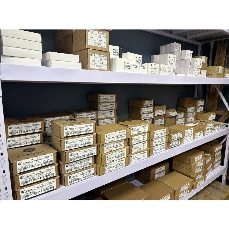 Allen-Bradley PLC parts boxes stacked on shelves, industrial automation components, new and refurbished