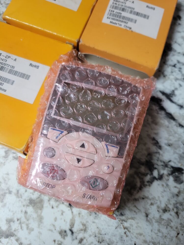 New ABB ACS-CP-A PLC module, pink control panel, in bubble wrap, RoHS compliant, with product box and labels.