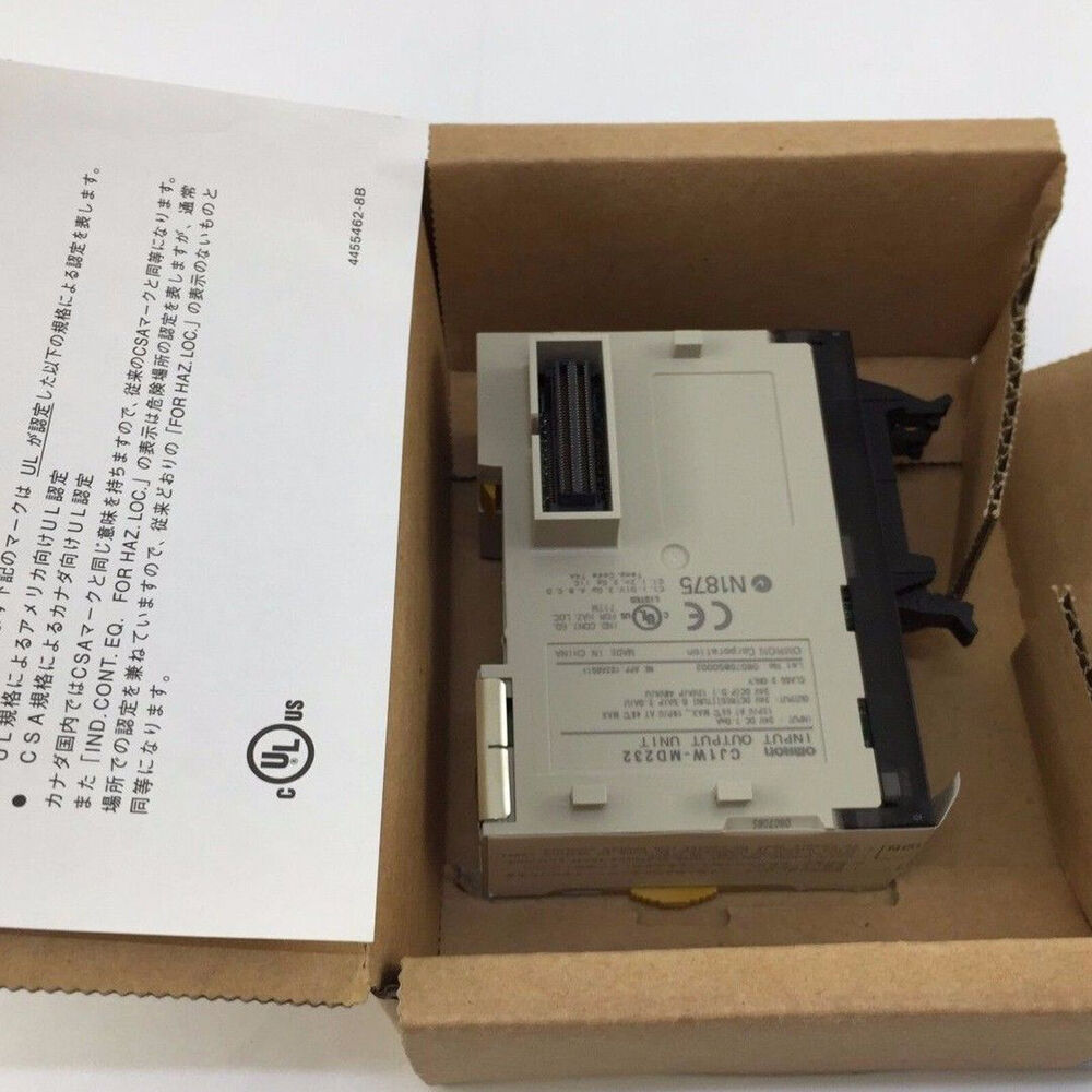 Omron CJ1W-MD232 PLC Module in its original box, showing model details and certifications.