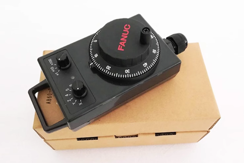 FANUC A860-0203-T015 Handwheel Pulse Generator, black control with dial, on a cardboard box, industrial automation part.
