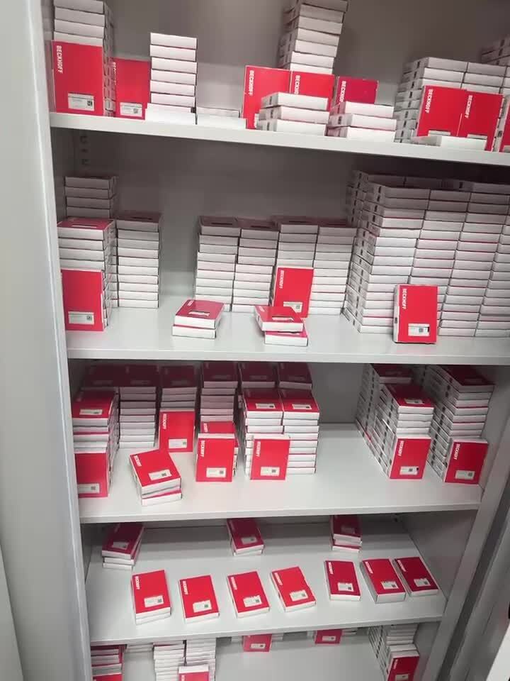 Beckhoff EL4124 PLC Modules in stock, ready for sale, with multiple boxes stacked on shelves.