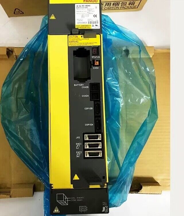 New Fanuc A06B-6124-H209 servo drive. Industrial automation part with warning labels, black and yellow.