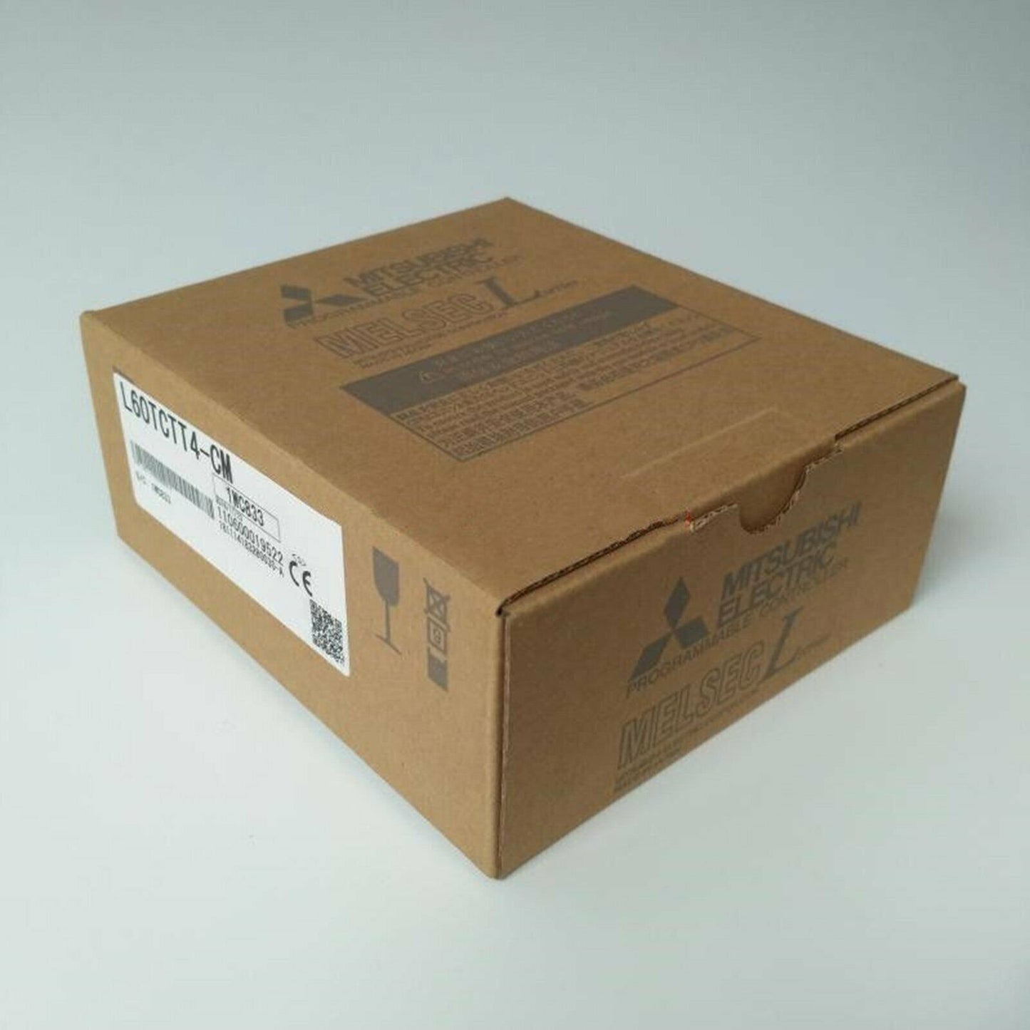 Mitsubishi L60TCTT4-CM PLC module in a cardboard box, product packaging