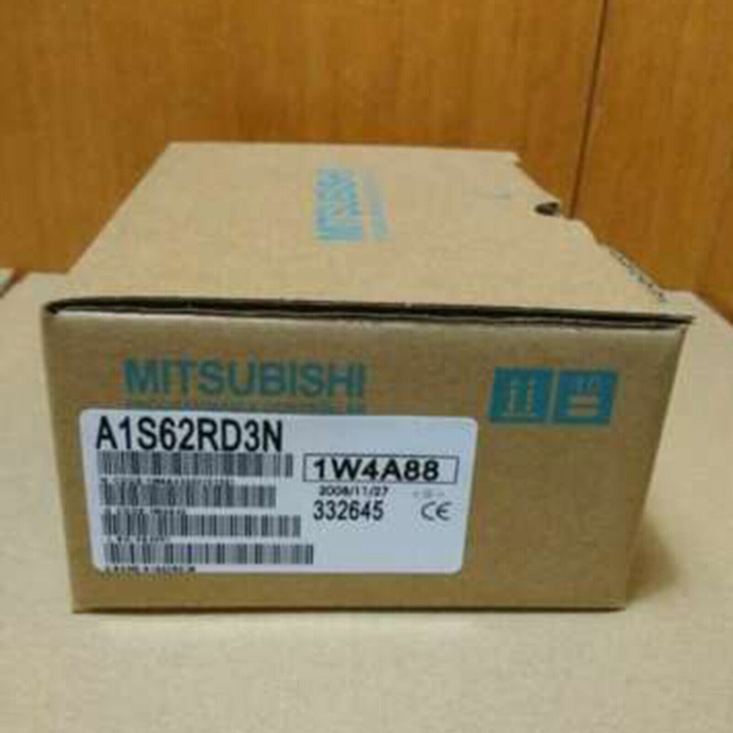 Mitsubishi A1S62RD3N PLC module box, brown cardboard, with product label