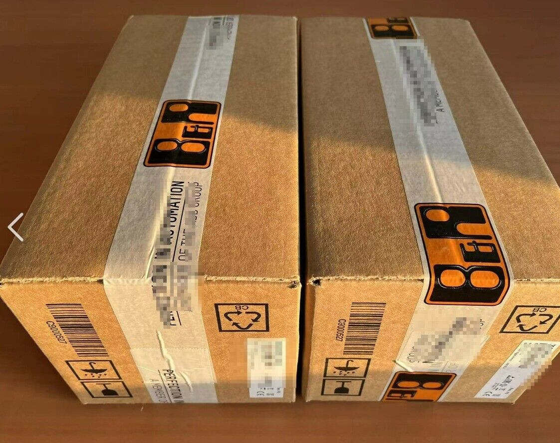 Two B&R servo motor boxes with shipping tape, barcode and labels, product packaging.