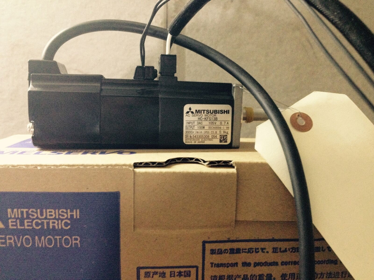 Mitsubishi HC-KFS13B servo motor on box, product details visible, industrial automation part, fast shipping.