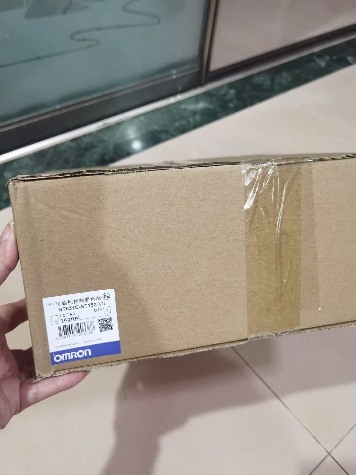 Omron NT631C-ST153-V3 Touch Panel in cardboard box, new industrial automation part with label.