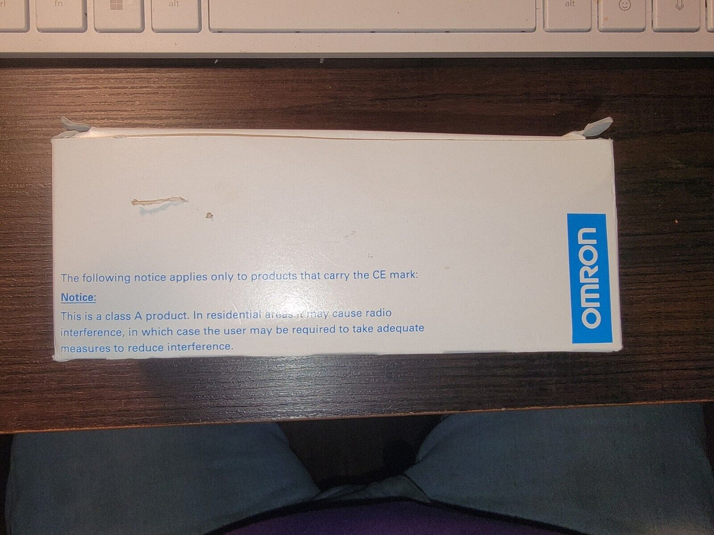 OMRON E3C-LDA21 Photoelectric Switch Box, white packaging with blue OMRON logo and warning text.