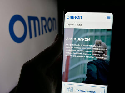Mobile phone displaying the OMRON website.
