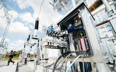An electrical control panel with open circuit breakers and wiring.