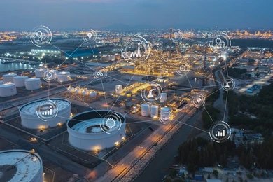 Aerial view of an industrial refinery with digital overlay icons representing technology and connections.