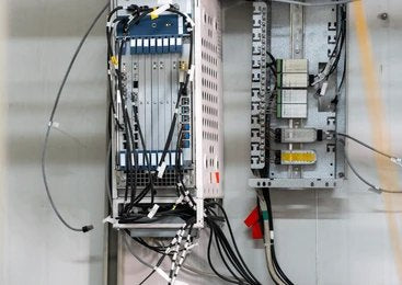 A telecommunications rack with network hardware and complex wiring.