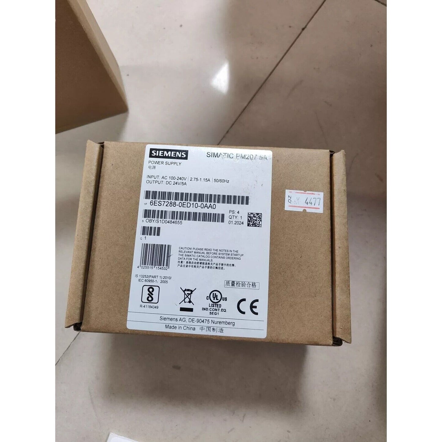 Siemens SIMATIC PM207 5A power supply unit, model 6ES7288-0ED10-0AA0, 24V DC output, in its original brown packaging.