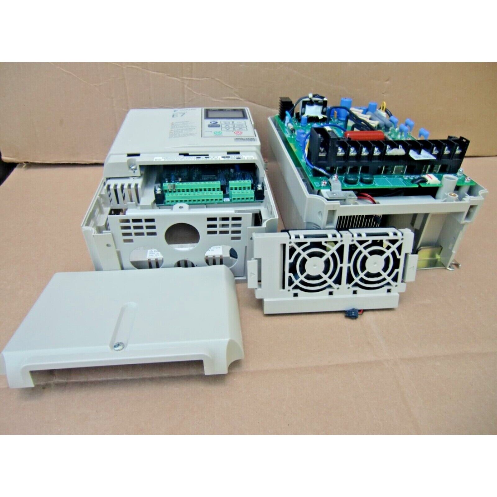YASKAWA E7 AC drive, internal components visible, beige casing, industrial automation part with control panel
