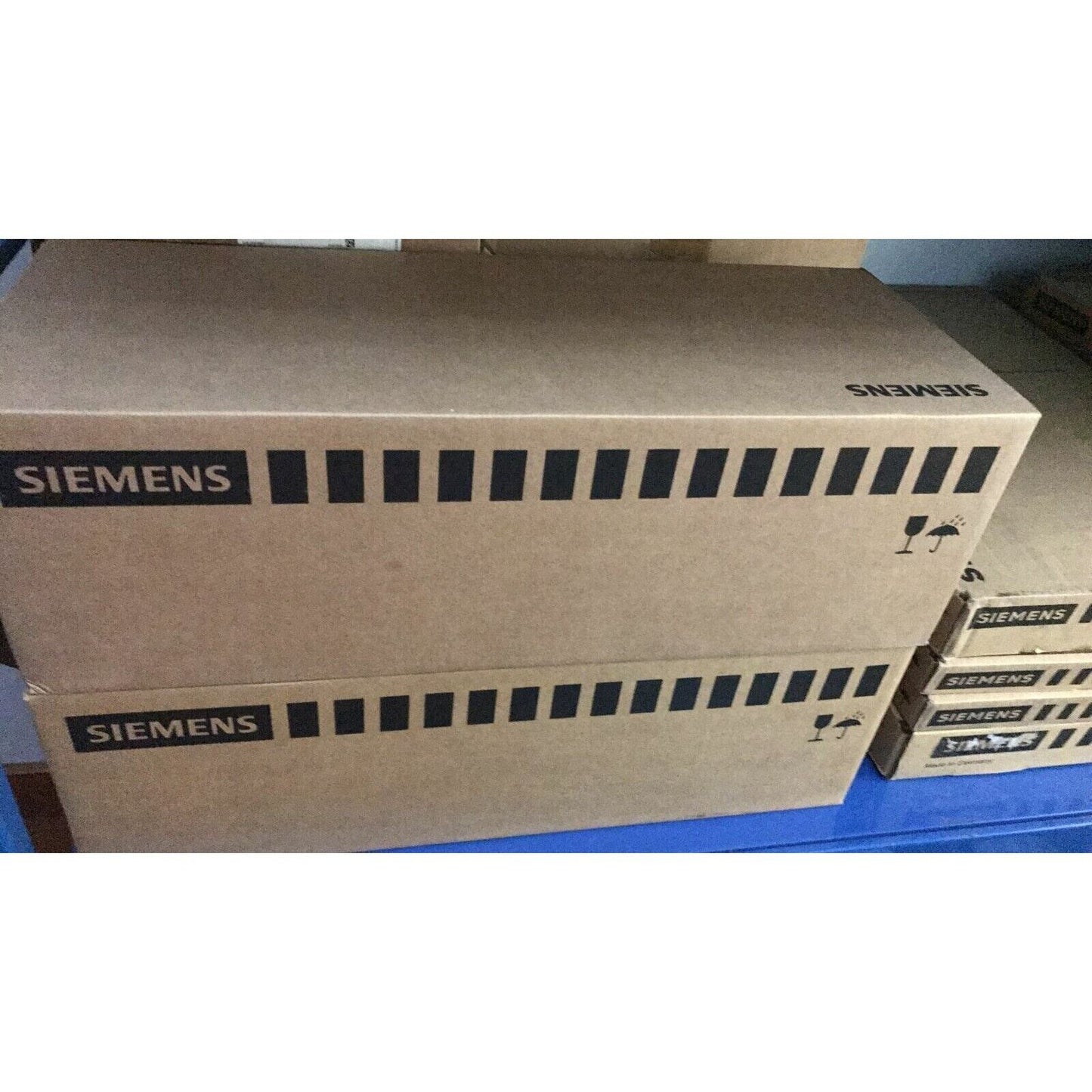 Siemens industrial automation parts packaging, PLC modules in brown boxes