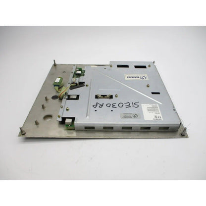 Siemens industrial control panel component, metallic with electronic parts. SIOE30RP marking, likely part of a PLC.