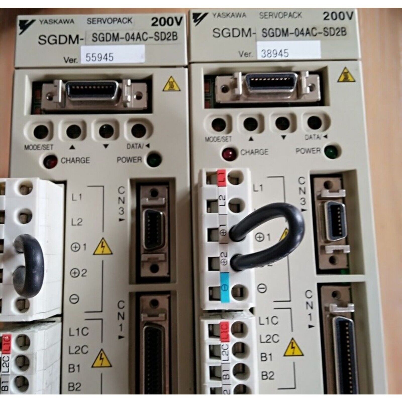 YASKAWA SGDM-04AC-SD2B servo drives with model numbers, labels, and warning symbols, industrial automation parts