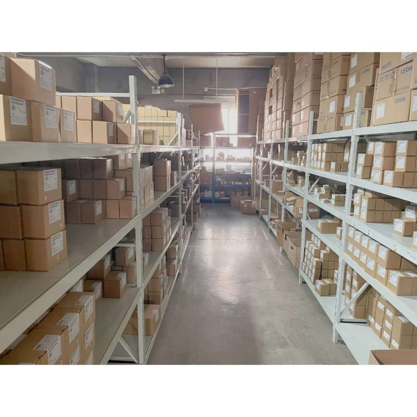 Warehouse shelves filled with boxes of Siemens automation products, perspective view