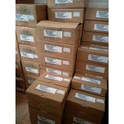 Yaskawa AC Servo Motors in boxes, various models. Industrial automation parts from Radwell International.