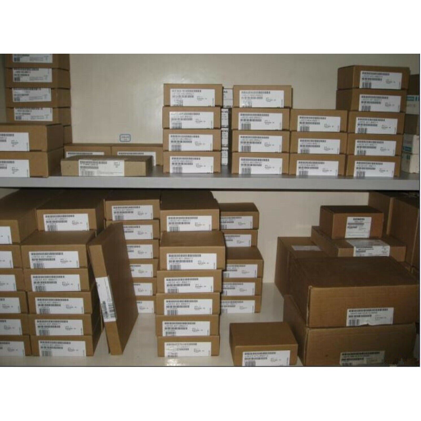 SIMATIC ET 200SP bus adapter modules in boxes on shelves, ready for shipment. Automation parts warehouse.