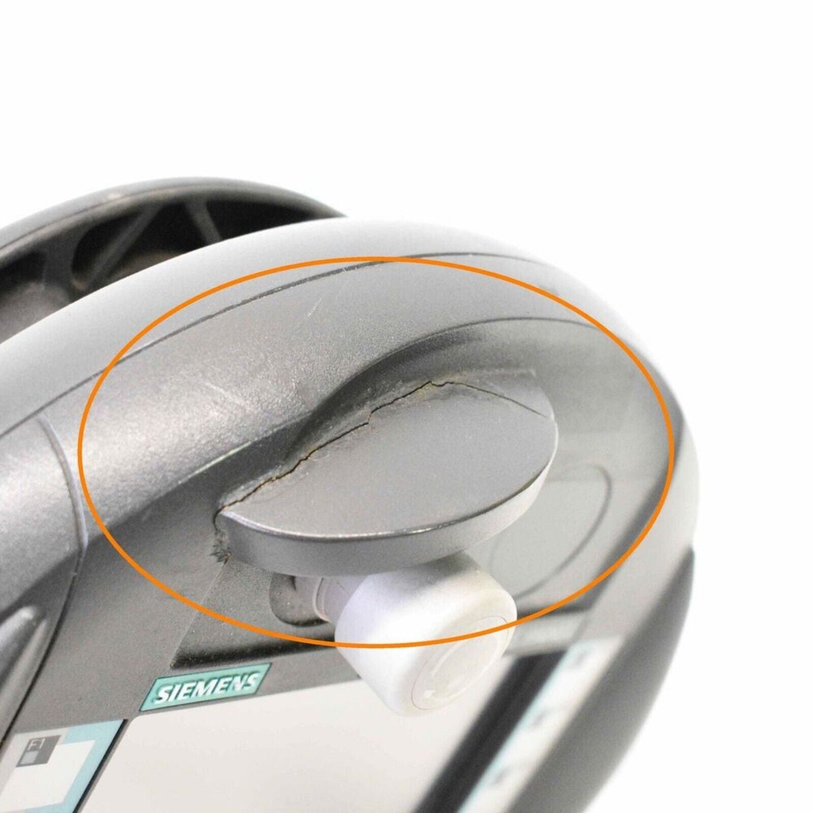 Close-up of a damaged Siemens SIMATIC Mobile Panel 177DP, displaying a cracked component.