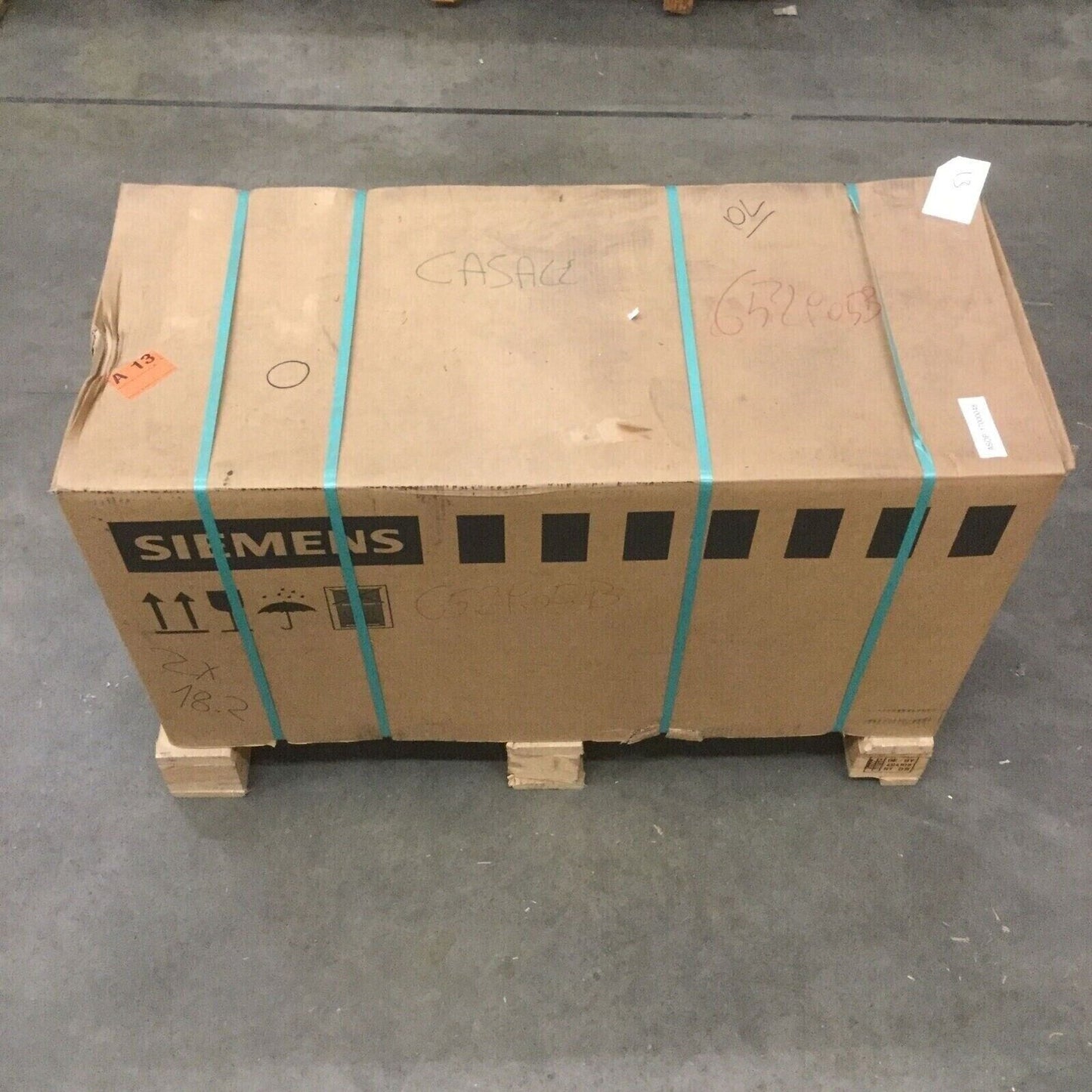 Siemens industrial automation part in a box, secured with straps, ready for shipping, part number visible.