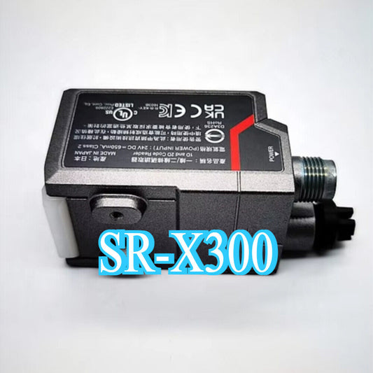 Keyence SR-X300 barcode reader. Industrial automation sensor with power connector and text.