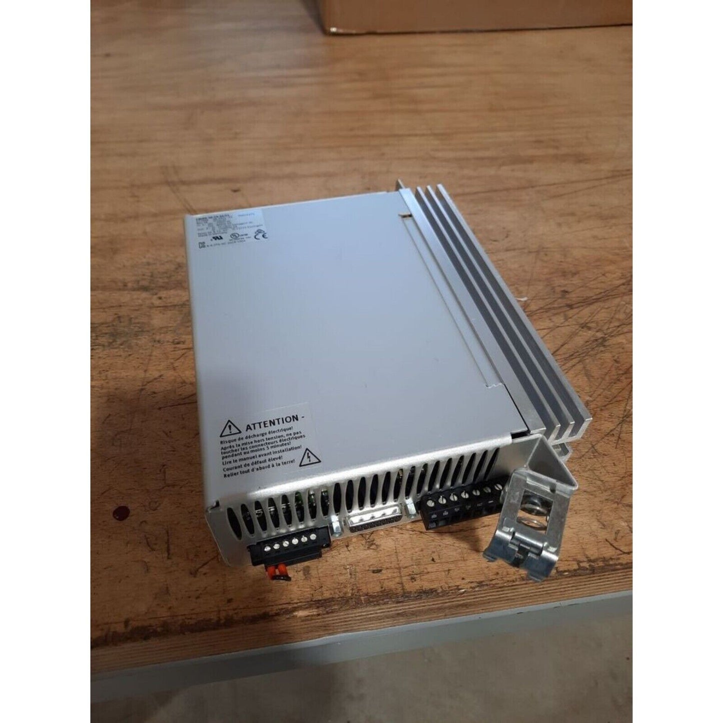 Festo CMMS-AS-C4-3A-G2 Motor Controller on wooden surface, industrial automation part.