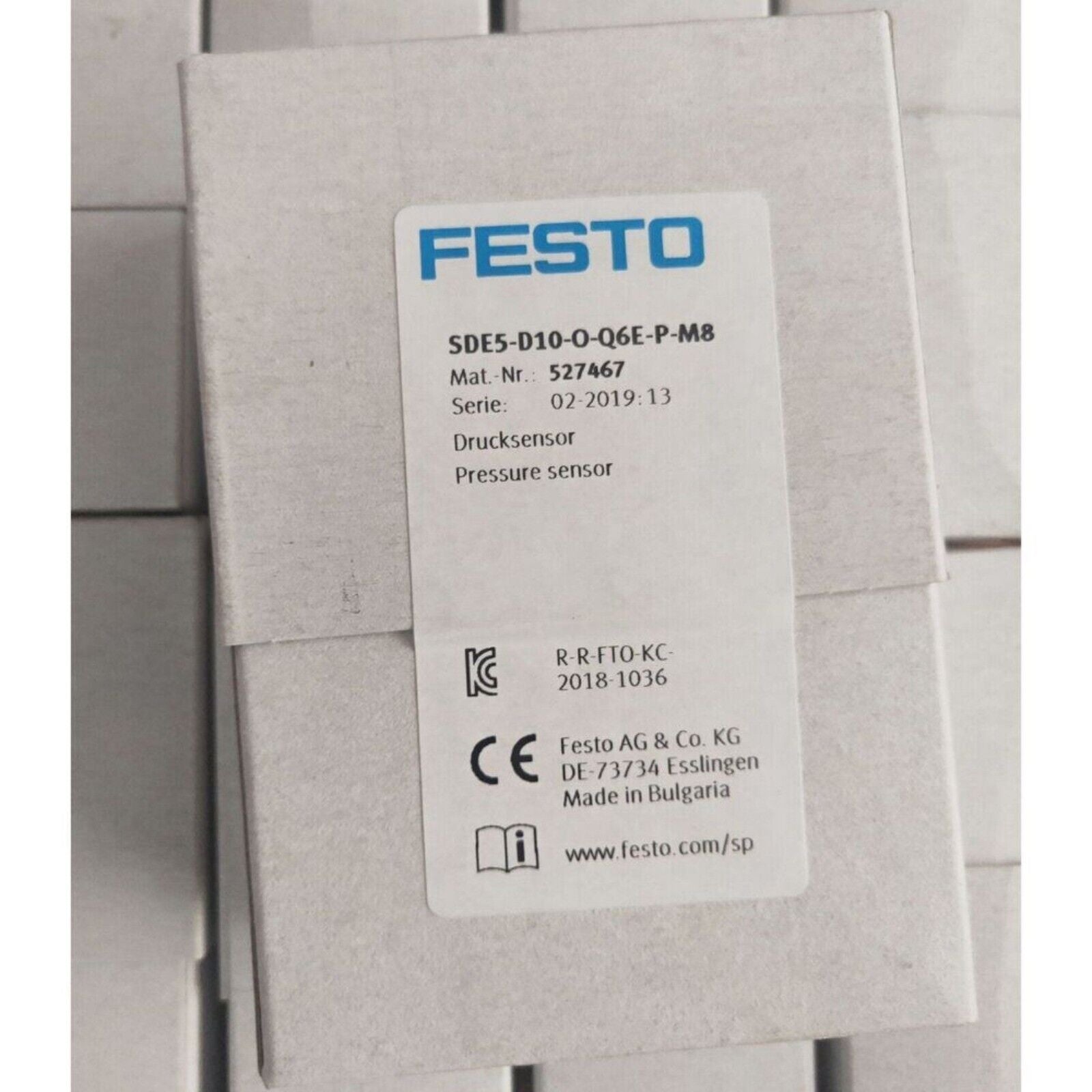 Festo SDE5-D10-O-Q6E-P-M8 pressure sensor in white box, industrial automation part.