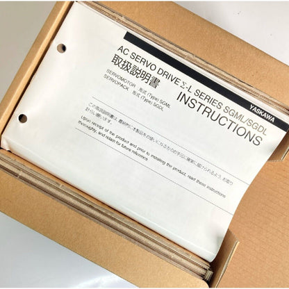 Yaskawa AC Servo Drive instructions in box. SGML/SGDL series documentation. New industrial automation parts.