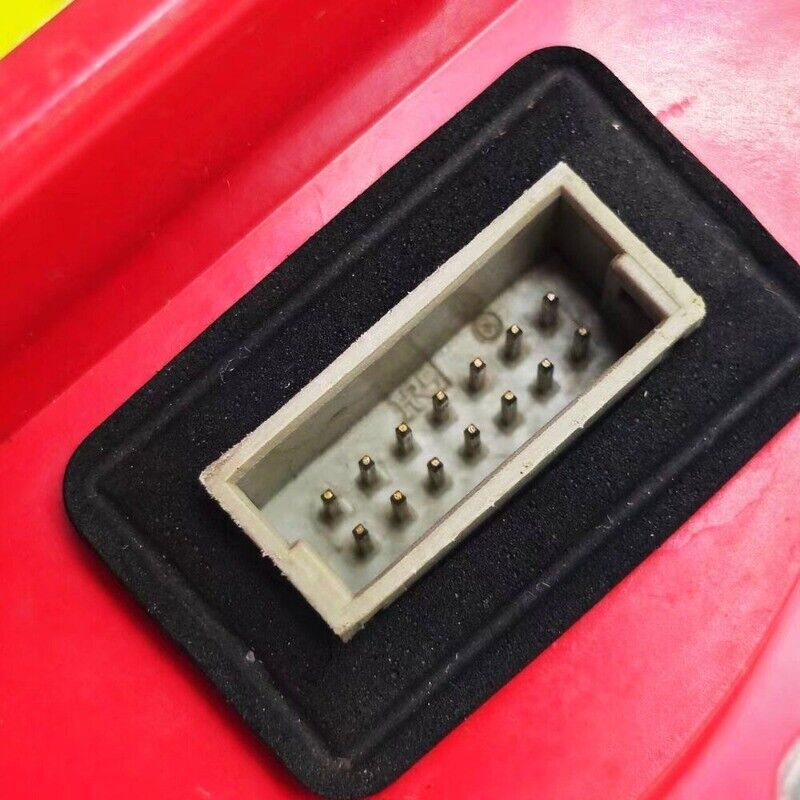 FANUC PLC component detail with connector pins, red casing. Industrial automation parts.