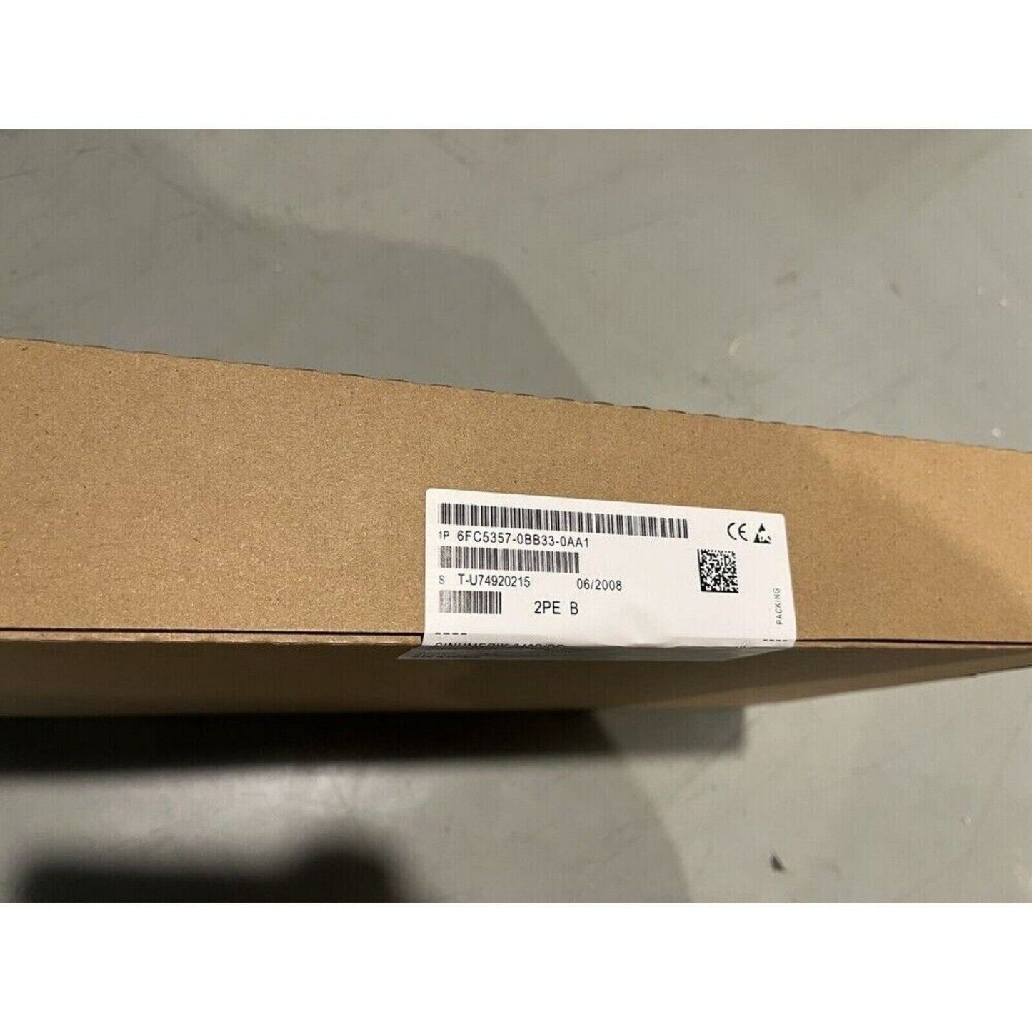 Siemens 6FC5357-0BB33-0AA1 PLC module packaging. Label with product details and manufacturing date.