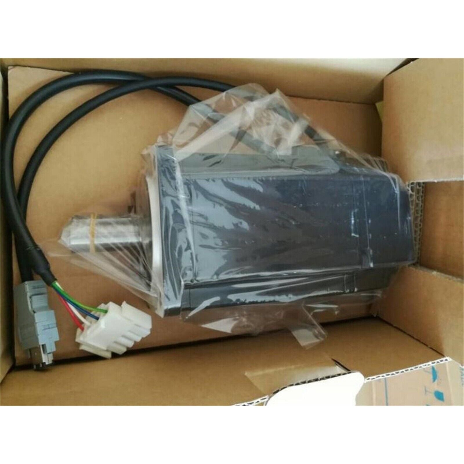 Yaskawa SGMAH-08AAF41 Servo Motor, black metal motor with cabling, packaged in cardboard box, industrial automation part.