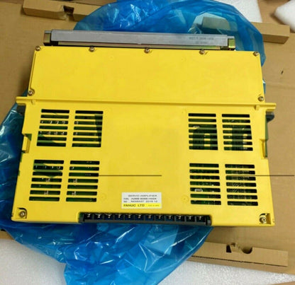 FANUC A06B-6066-H004 AC Servo Amplifier, Yellow industrial equipment with vents.