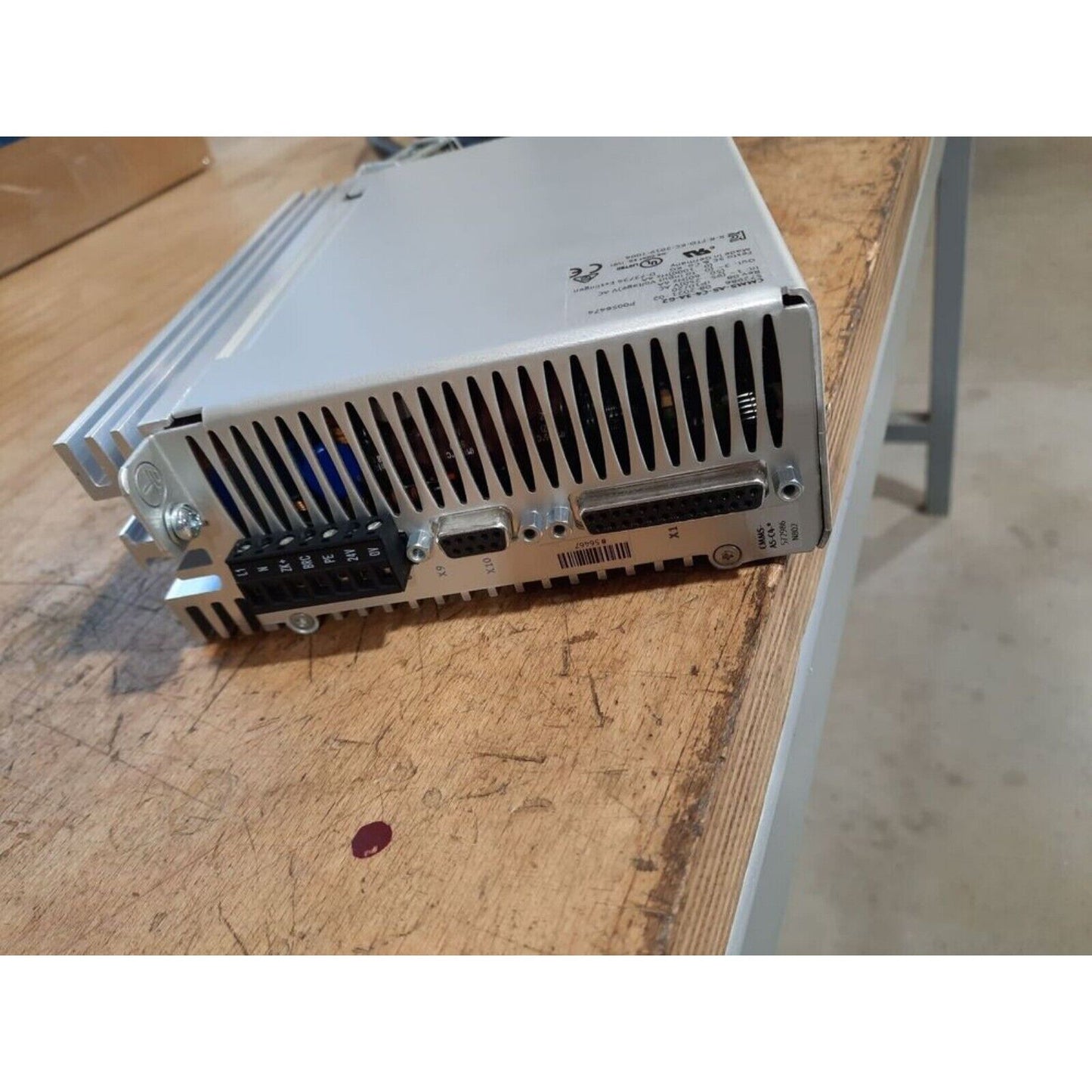 Festo CMMS-AS-C4-3A-G2 Motor Controller. Silver industrial automation equipment on a wooden surface.