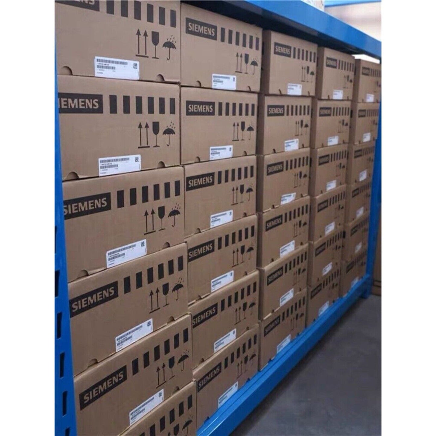 Siemens industrial automation parts boxes stacked on a warehouse shelf