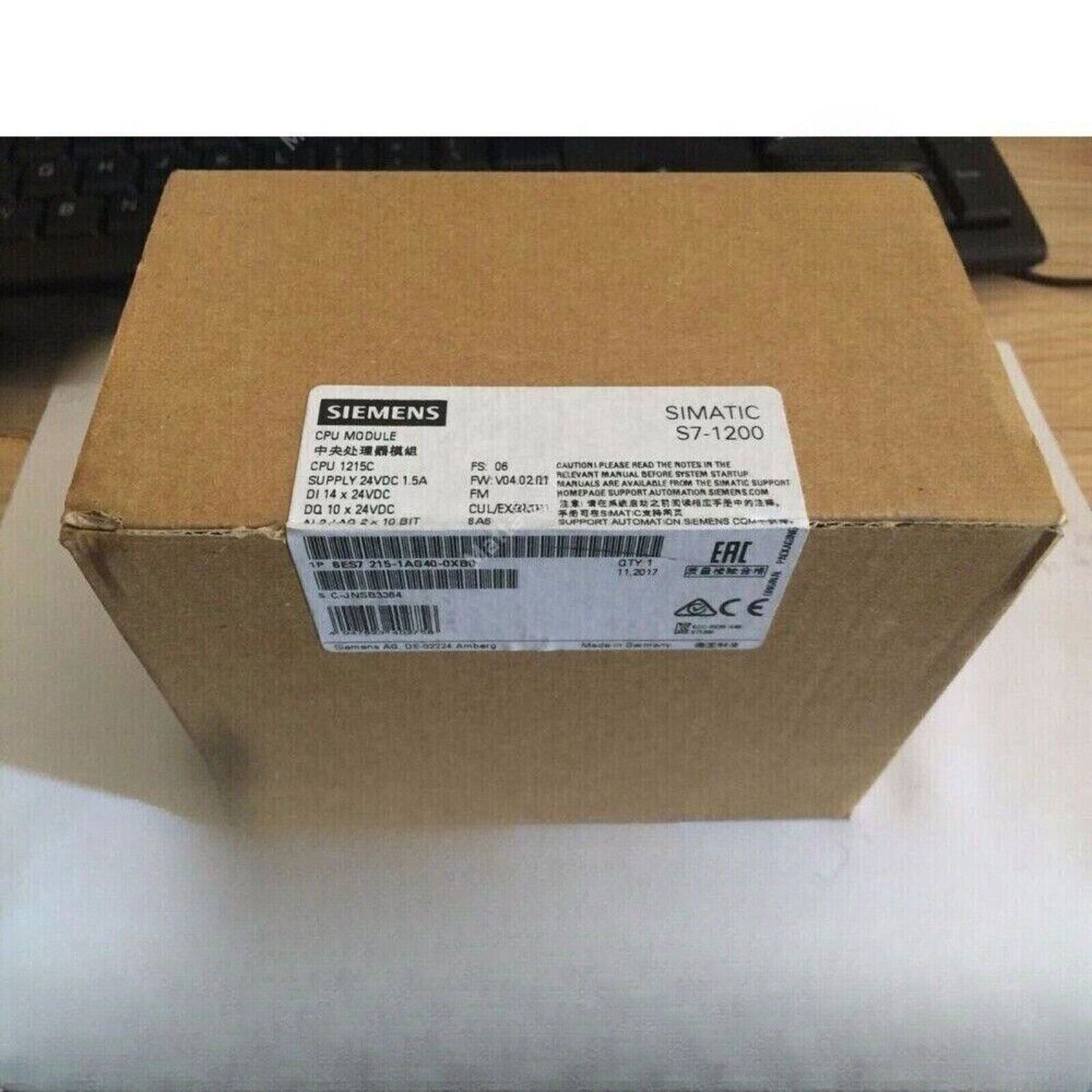 Siemens SIMATIC S7-1200 CPU 1215C module box, 6ES7215-1AG40-0XB0, cardboard packaging, industrial automation.