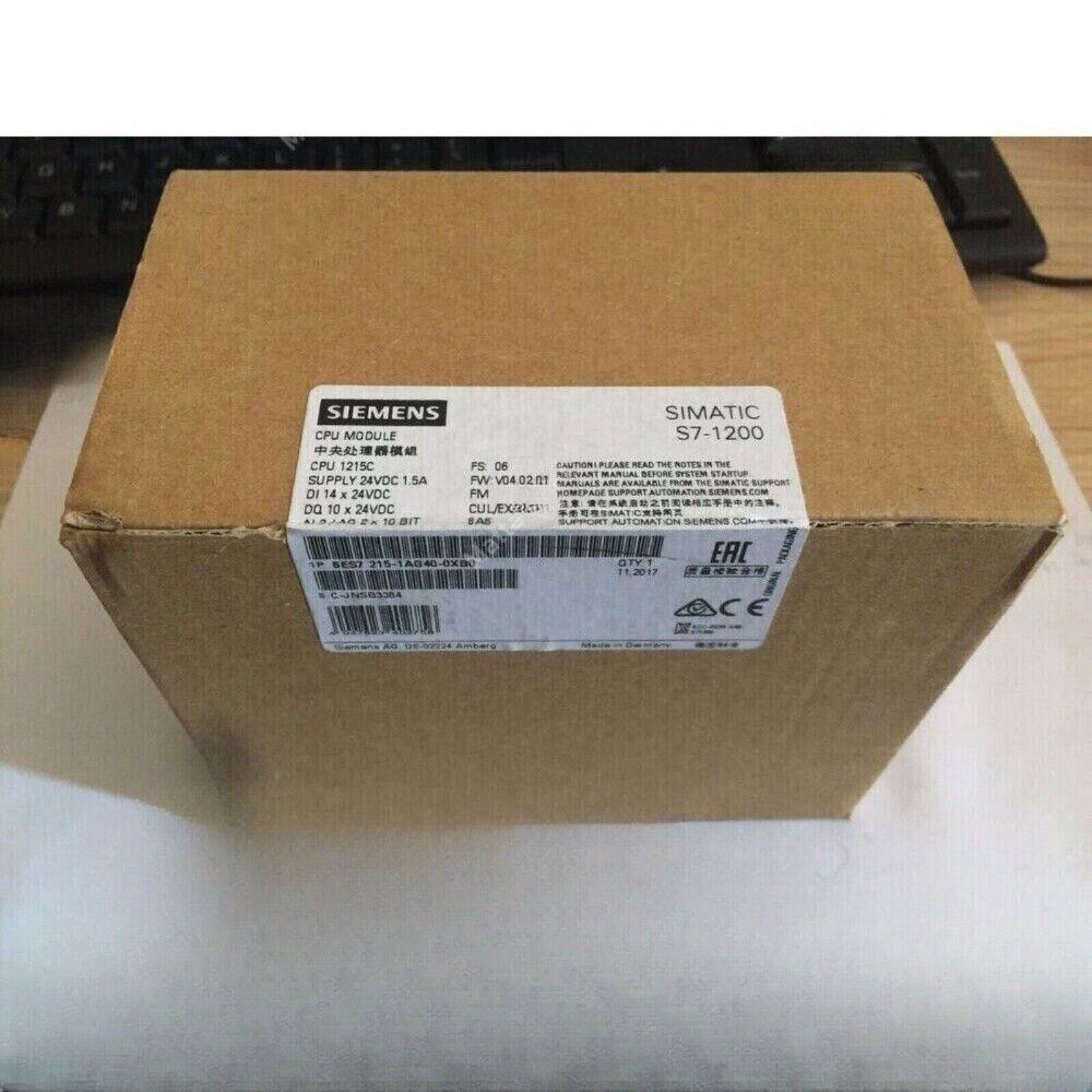 Siemens SIMATIC S7-1200 CPU 1215C module box, 6ES7215-1AG40-0XB0, cardboard packaging, industrial automation.