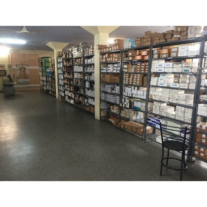Industrial automation parts warehouse stocked with Siemens PLC components and other equipment.