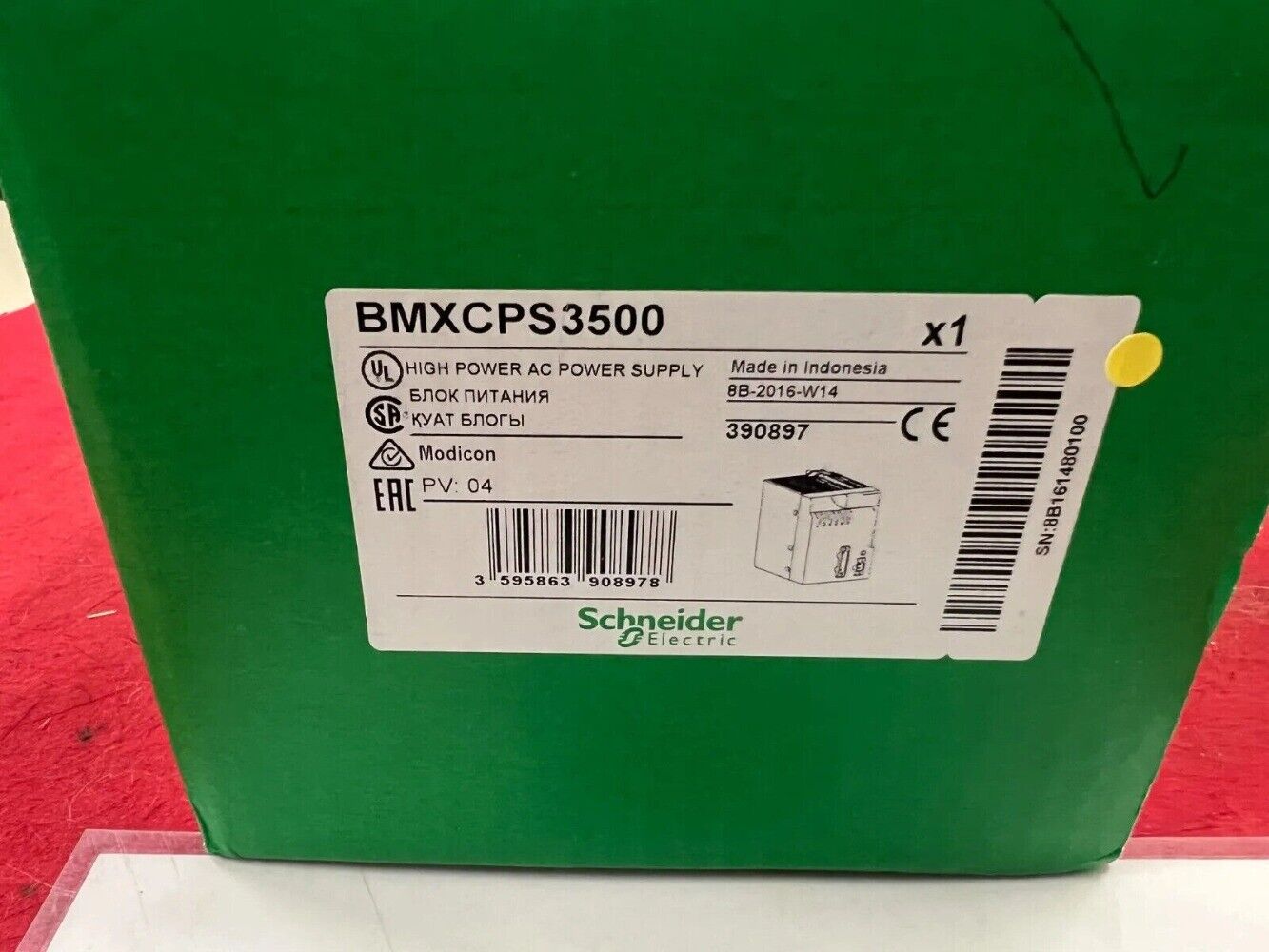 Schneider Electric BMXCPS3500 Power Supply Unit on a green box, industrial automation parts